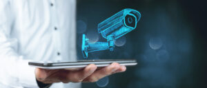 Close up of hand of virtual camera with security icons coming out of it, blurry background